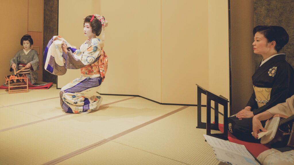 Geisha performing traditional dance with shamisen accompaniment