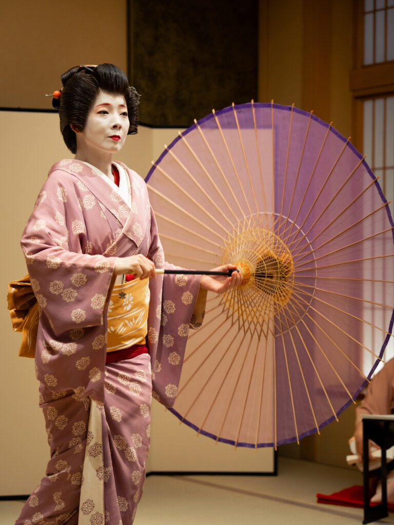 Geisha performing traditional fan dance in Asakusa