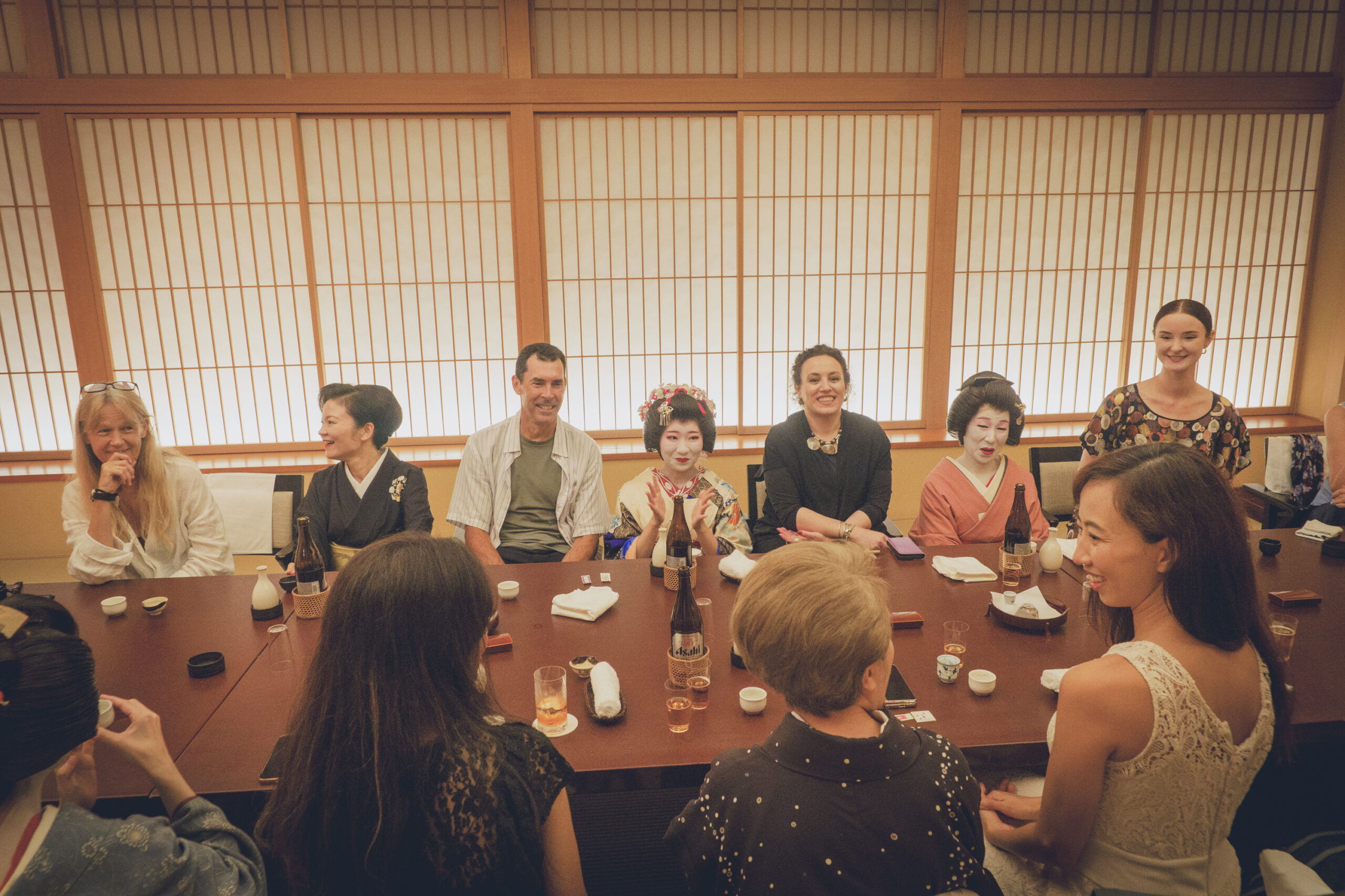 Geisha leading ozashiki asobi traditional games with guests at a private banquet in Asakusa