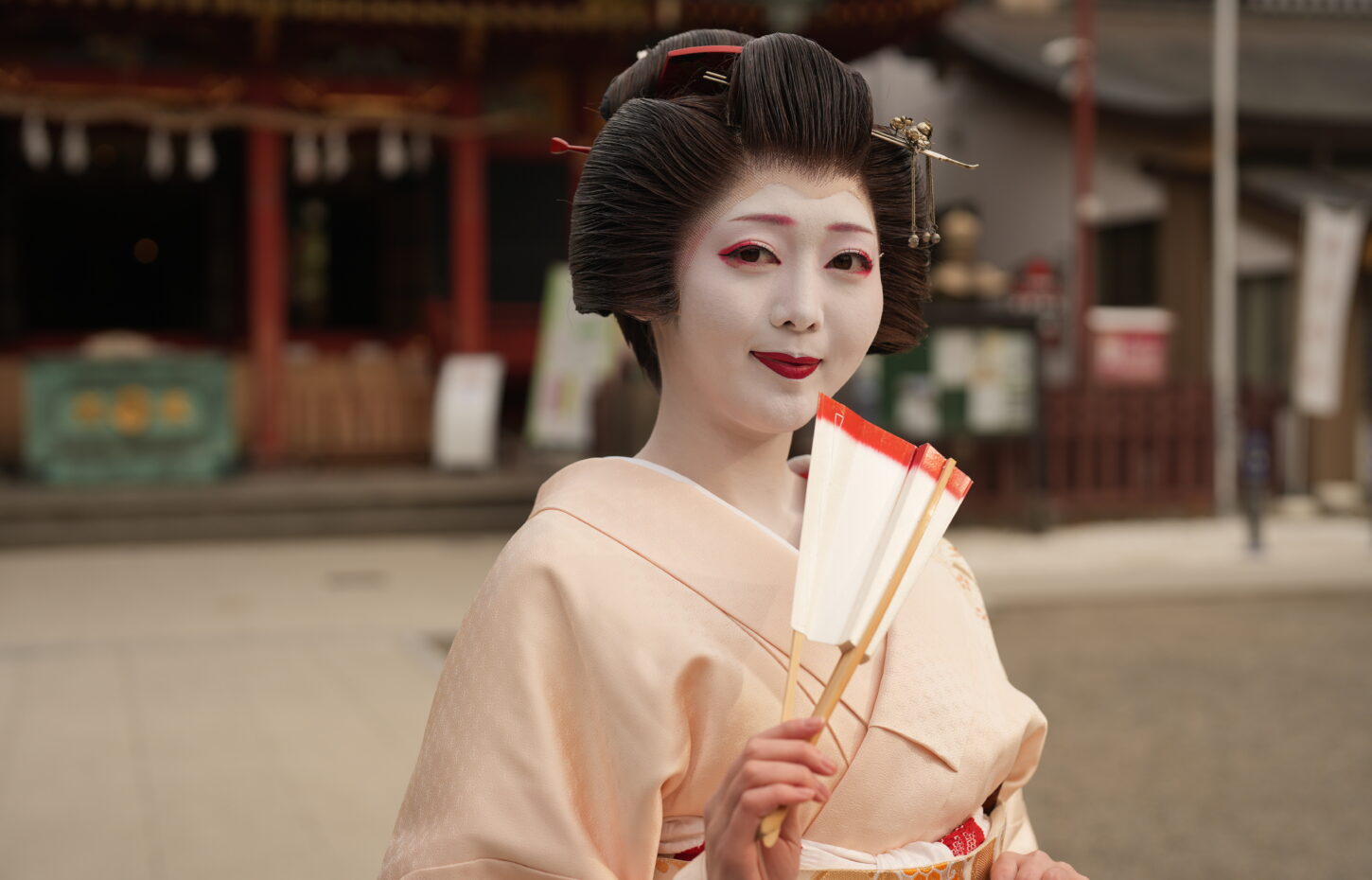 A geisha in elegant kimono at a traditional Japanese dinner setting