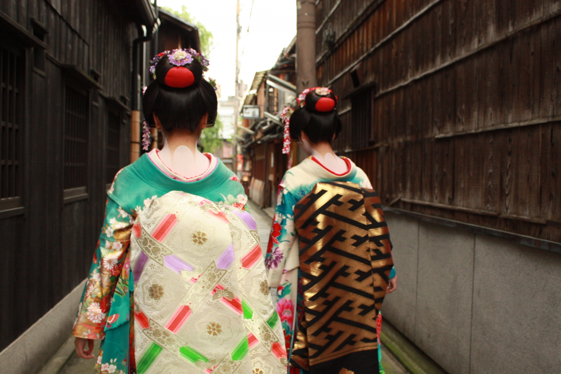 Maiko walking on cobblestone streets in Gion district, Kyoto