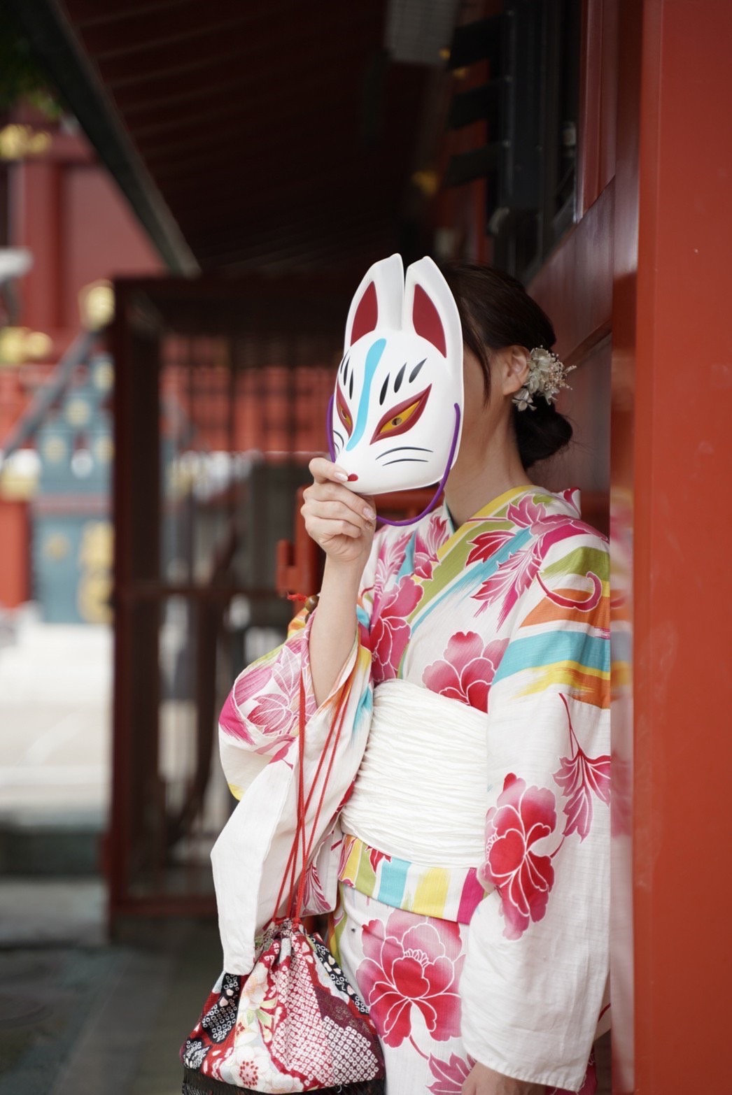 Tourists in colorful kimono enjoying a rickshaw ride through Asakusa temple grounds
