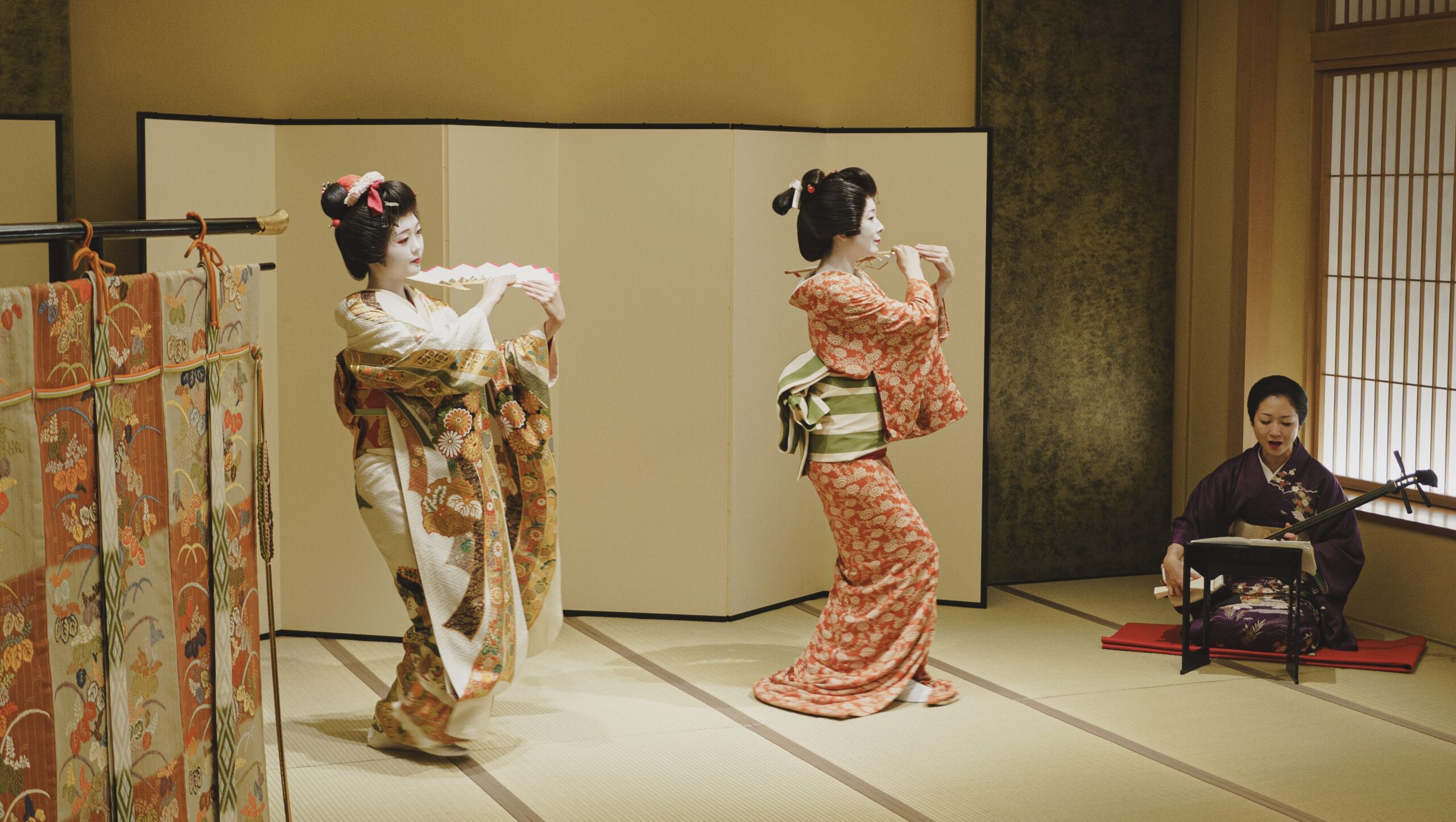 Three Asakusa geisha performing together at an ozashiki session