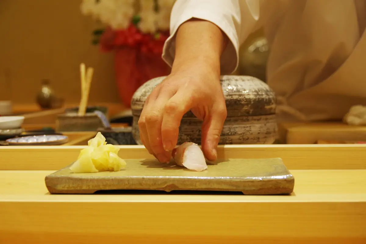 Ginza sushi counter with master chef preparing omakase nigiri sushi