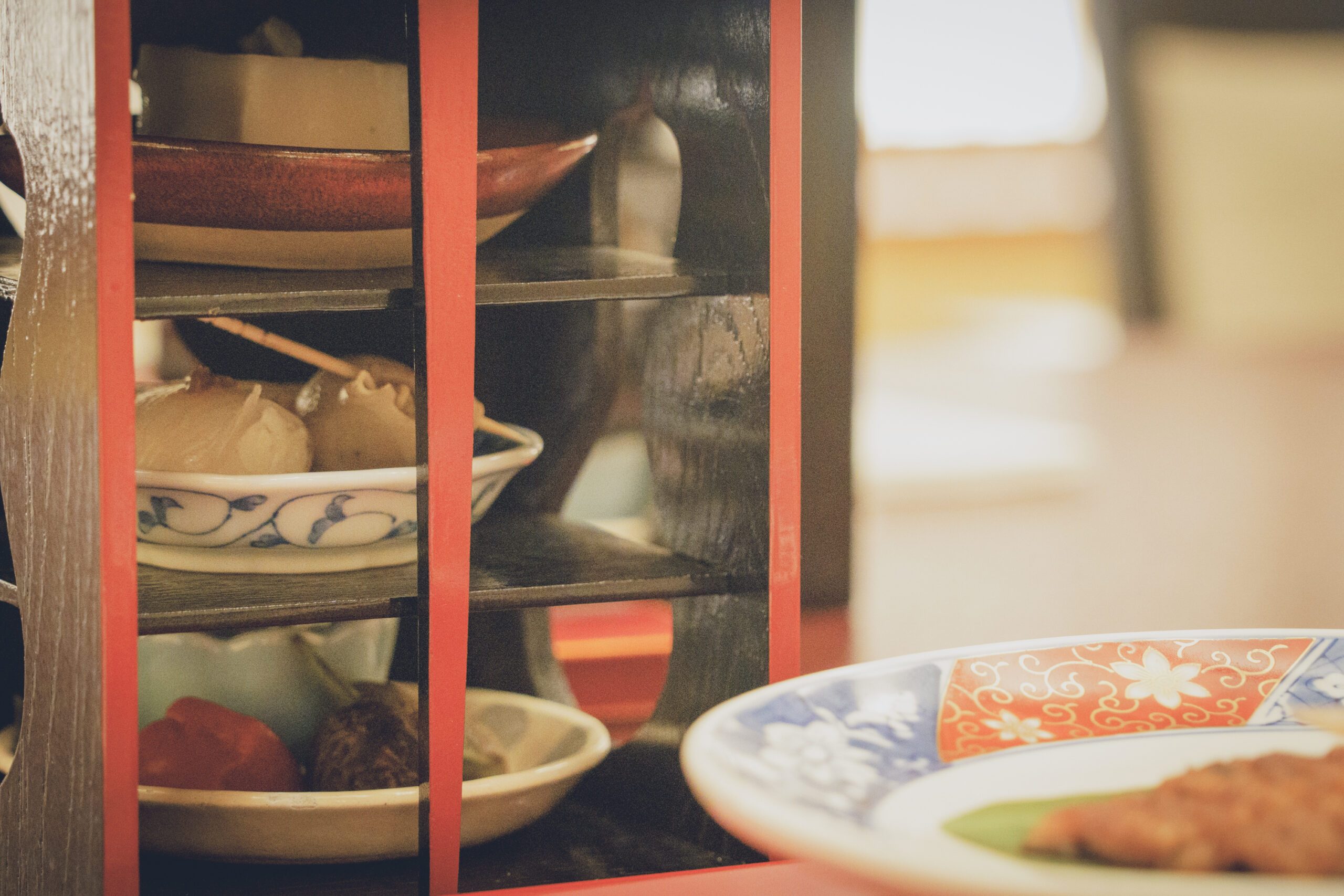 Seasonal Japanese dishes served in tiered lacquerware and on a colorful Imari-style plate at a private geisha dinner at Miyakodori in Asakusa