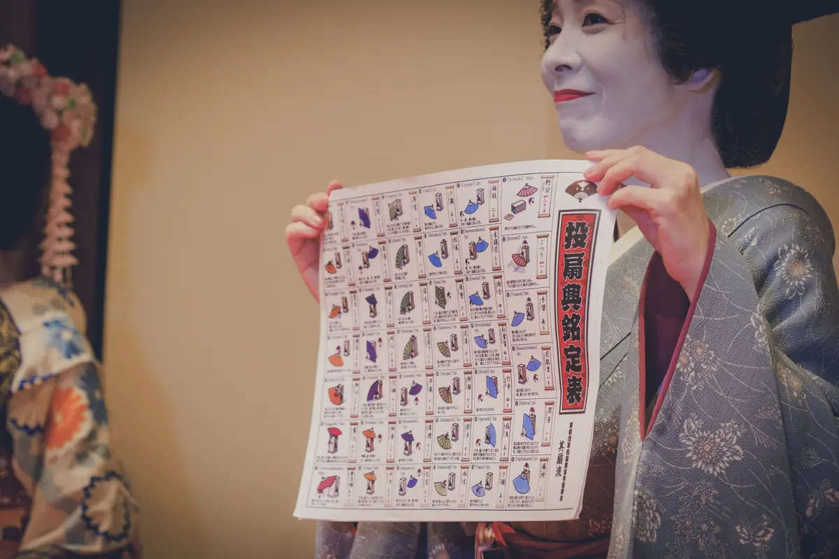 Asakusa geisha explaining ozashiki game rules to guests
