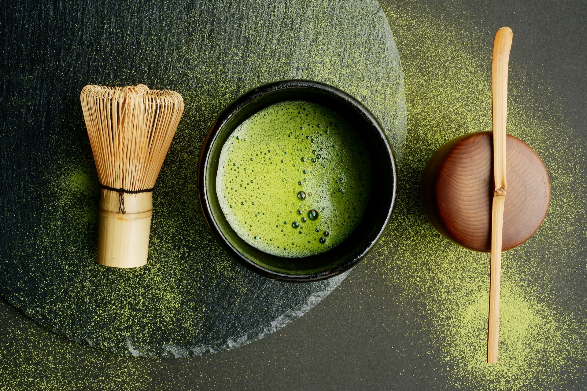 Matcha tea bowl, bamboo whisk and scoop arranged for a Japanese tea ceremony
