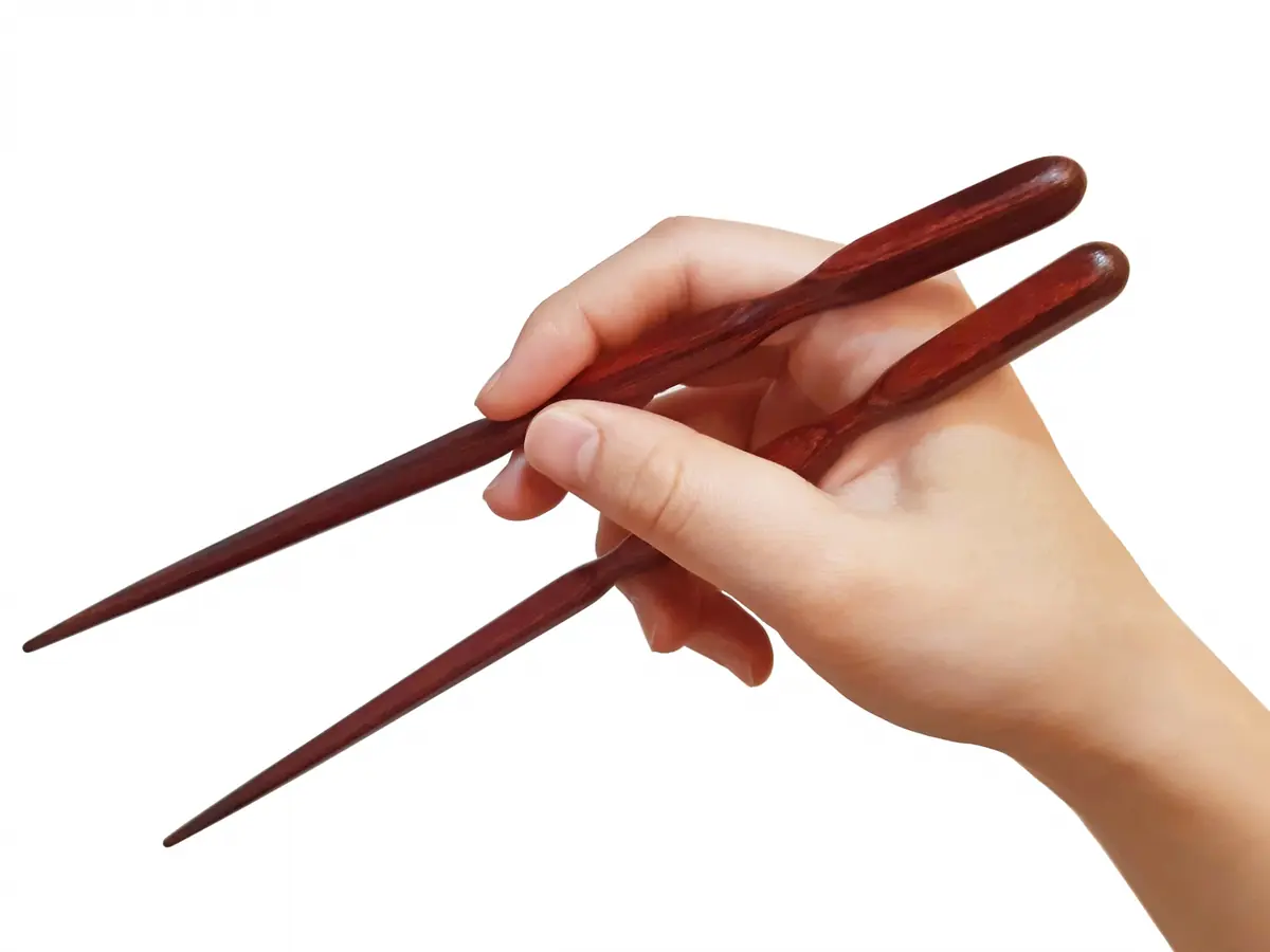 Practicing Japanese dining etiquette with chopsticks at a Tokyo restaurant