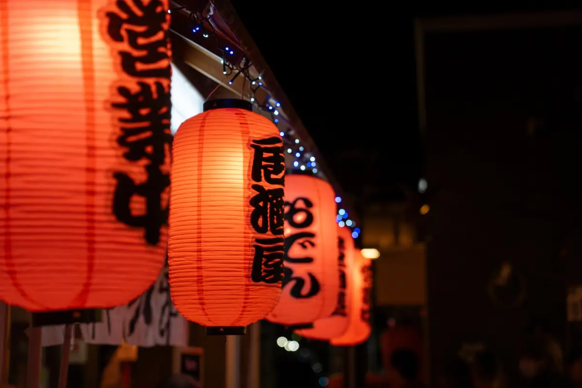 Traditional Asakusa izakaya with red lantern and yakitori over binchotan charcoal