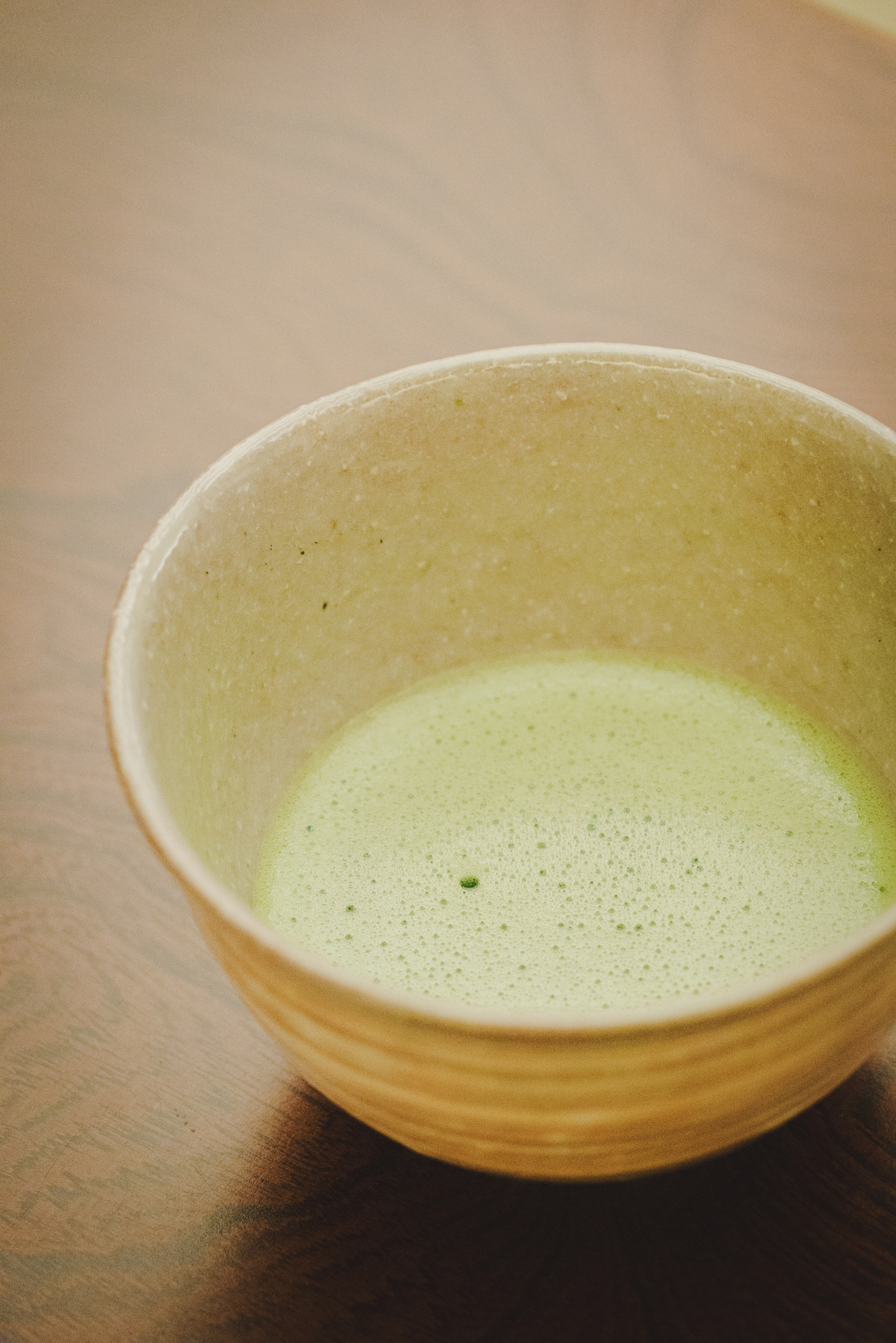 A bowl of freshly whisked matcha, the central element of a Japanese tea ceremony — powdered green tea with a fine froth on the surface