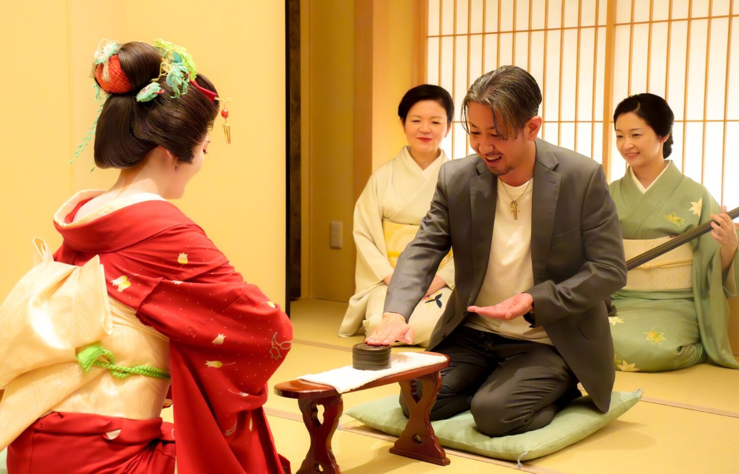 An ozashiki game of konpira fune fune being played at Miyakodori — guests and geisha face each other at a low lacquered armrest, tapping in rhythm