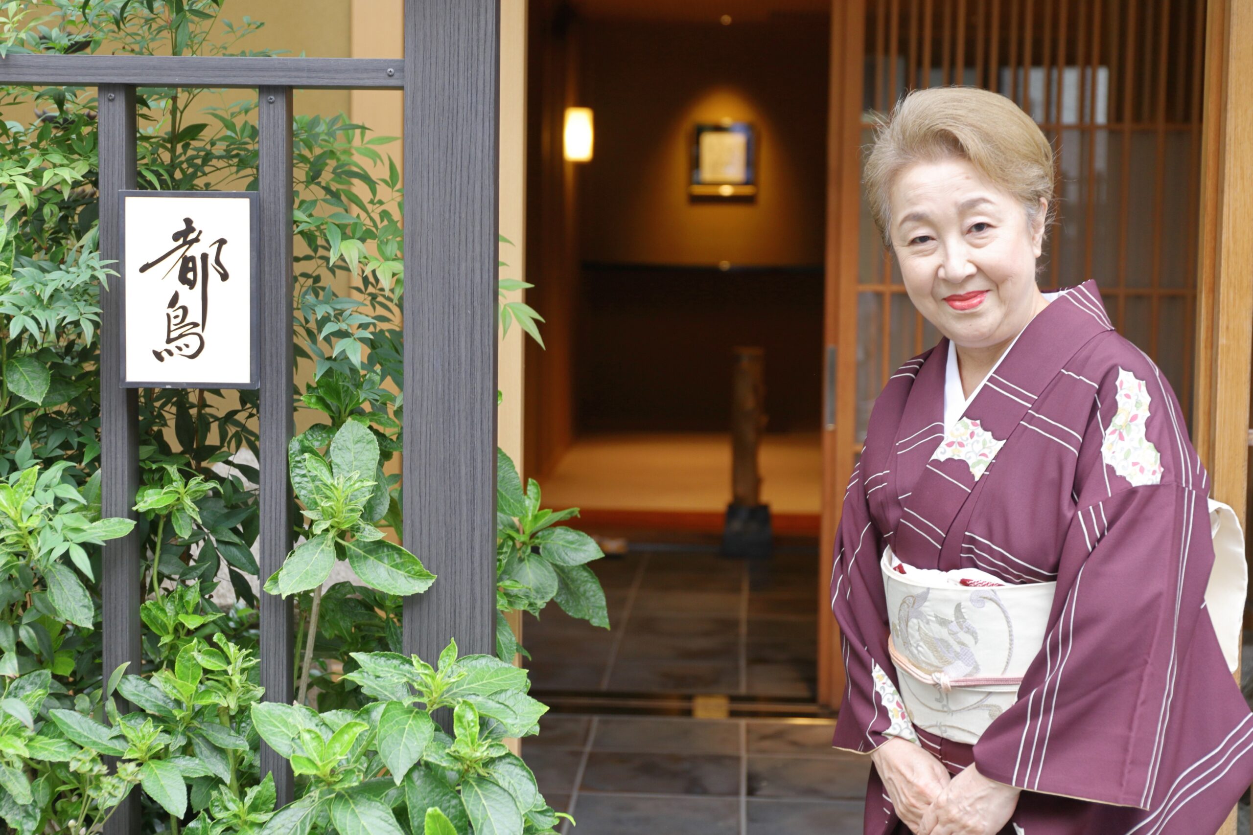 An Asakusa geisha welcoming guests at the entrance of Miyakodori — the house that chose to open a door that had long been closed