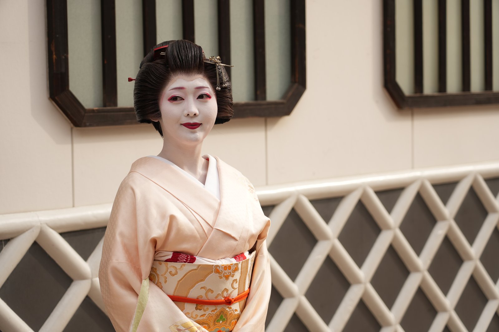 An Asakusa geisha in white makeup and nihongami, the person of art the word geisha literally names
