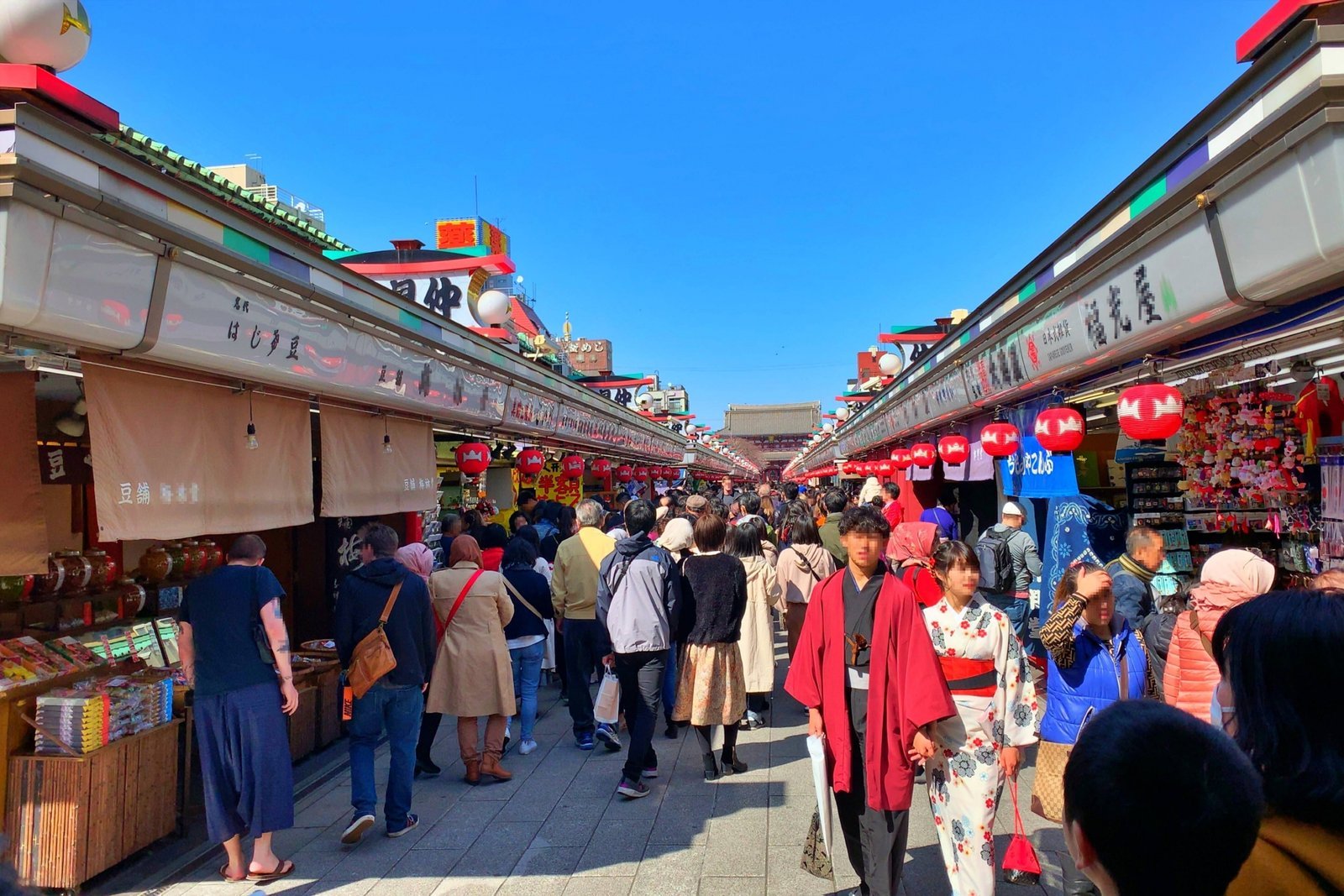 Nakamise-dori in Asakusa during the day, the shopping street between Kaminarimon and Sensō-ji lined with small shops, with visitors in kimono walking through