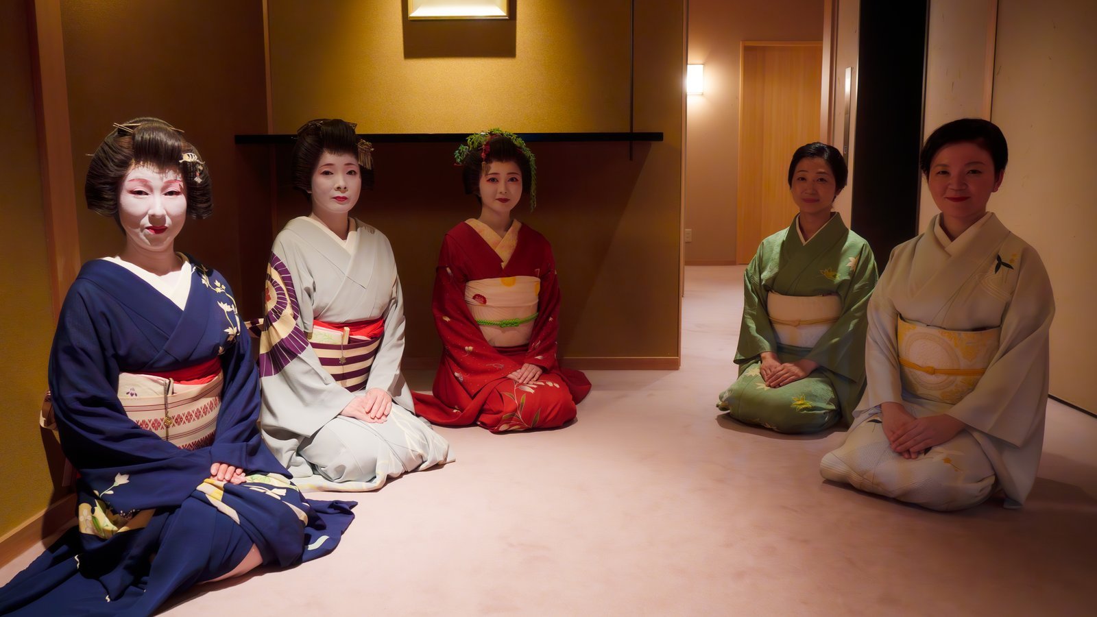 Geisha seated along the corridor of Miyakodori's understated tatami rooms, kept simple so the performers remain the focus