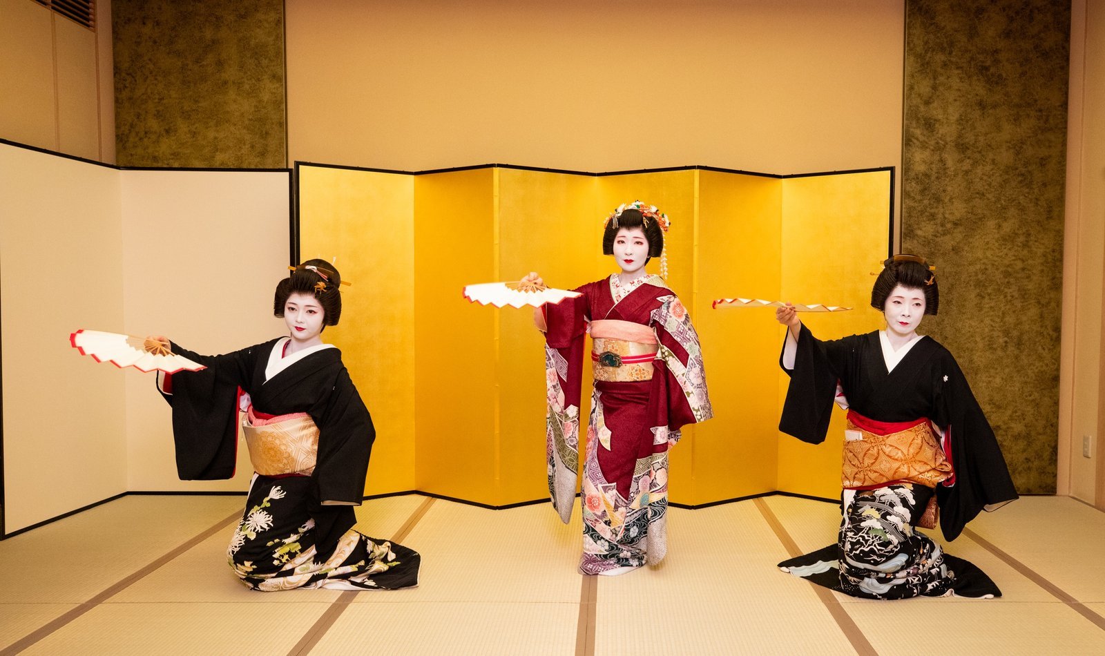 An Asakusa geisha performing a classical dance on tatami in a private ozashiki room at Miyakodori