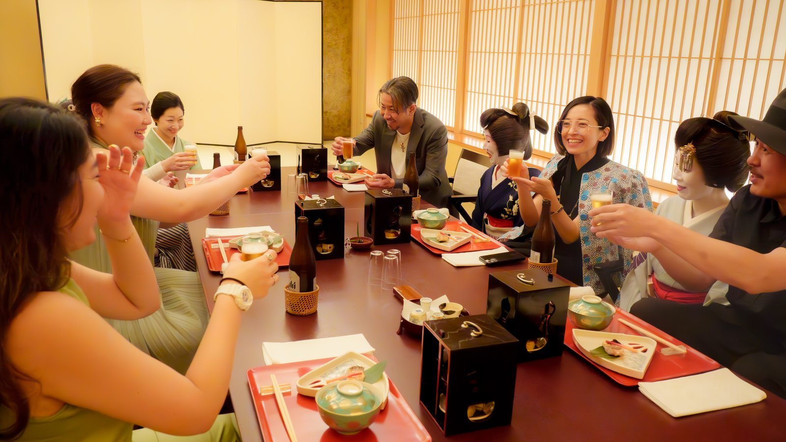 A group of guests seated together at one long table in a private room at Miyakodori