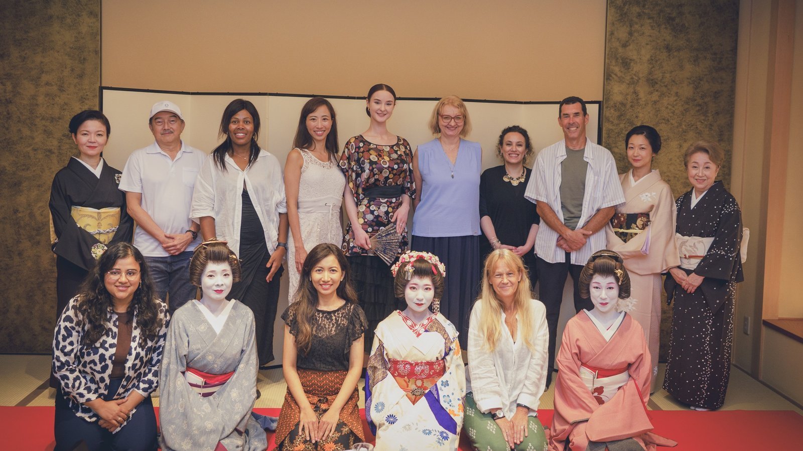 Geisha and guests lined up together for a commemorative group photo at the end of a private dinner in Asakusa