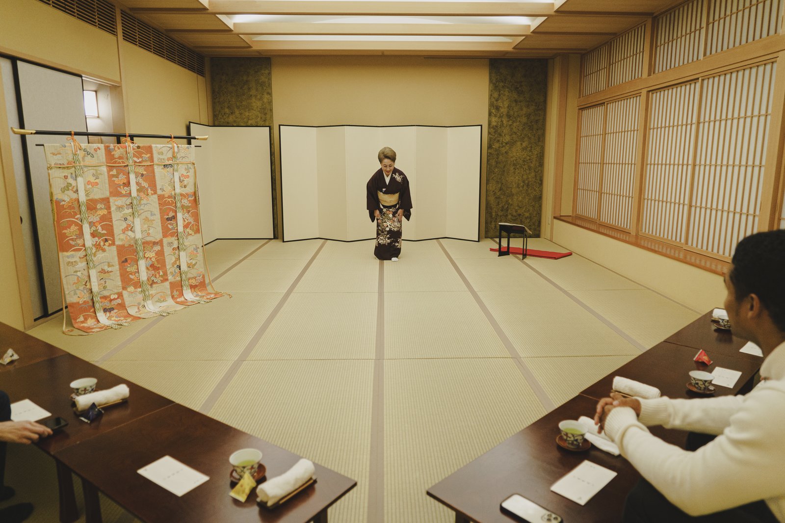 Guests seated together with other visitors at a shared table during an Ozashiki Tea House session at Miyakodori in Asakusa