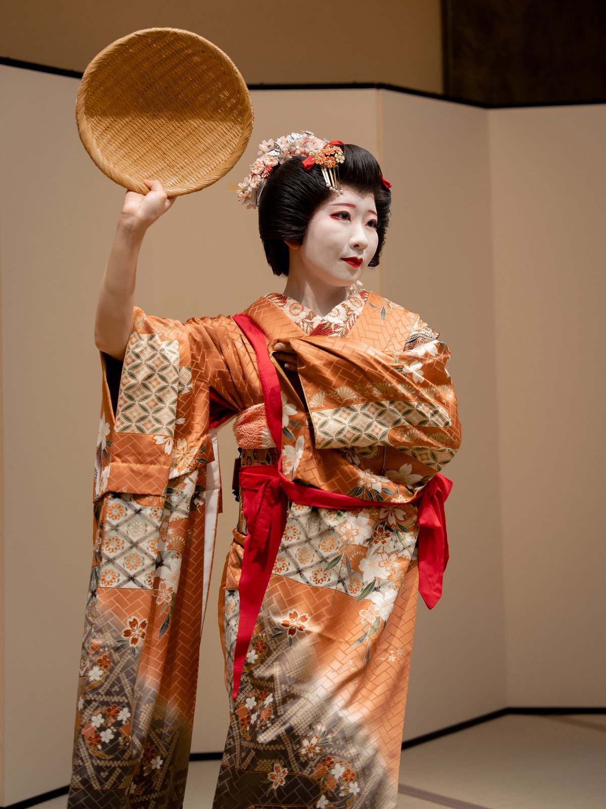 An Asakusa geisha mid-dance, the turn of a wrist caught in a private tatami room