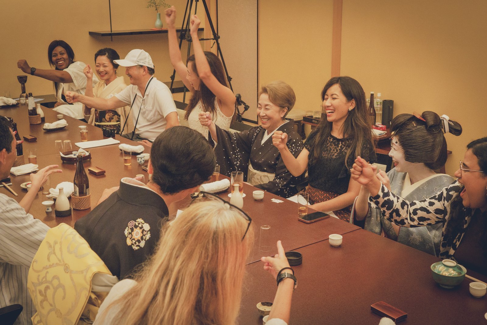 Guests and geisha laughing together at the end of an ozashiki evening in Asakusa