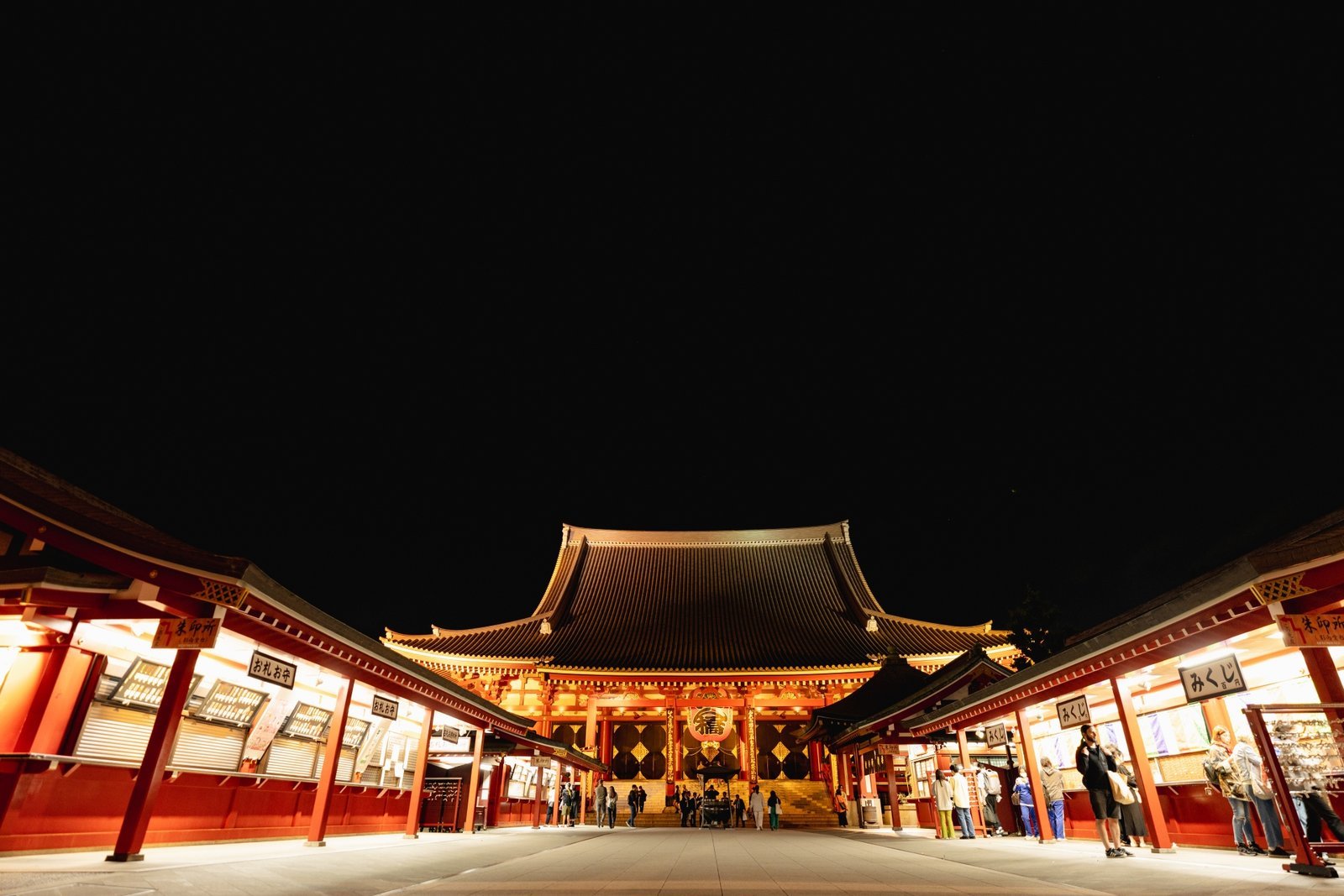 Senso-ji's main hall lit up at night, the temple grounds that Sanja Matsuri fills each May