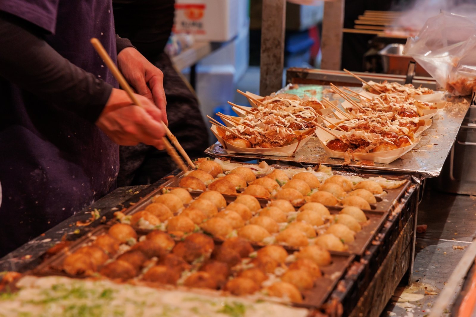 A takoyaki stall at work, one of the festival foods that line the streets around Senso-ji during Sanja Matsuri
