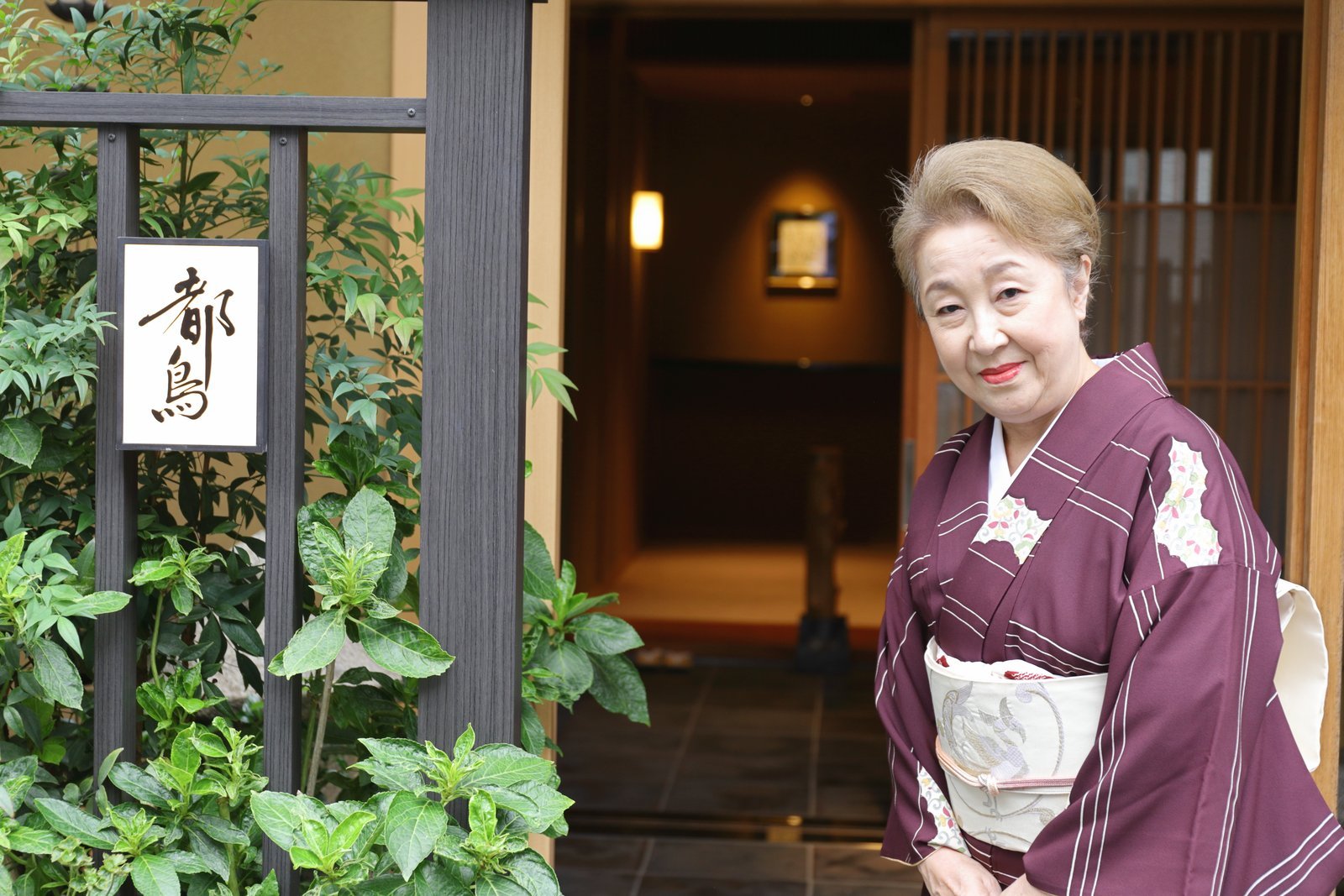 The okami of Miyakodori, an Asakusa geisha for twenty-seven years, in the entrance of the teahouse