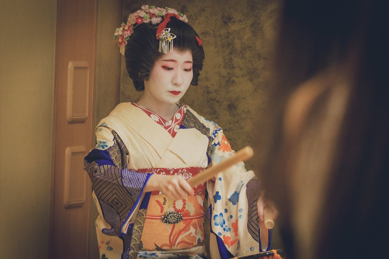 An Asakusa hangyoku playing the drum at an ozashiki