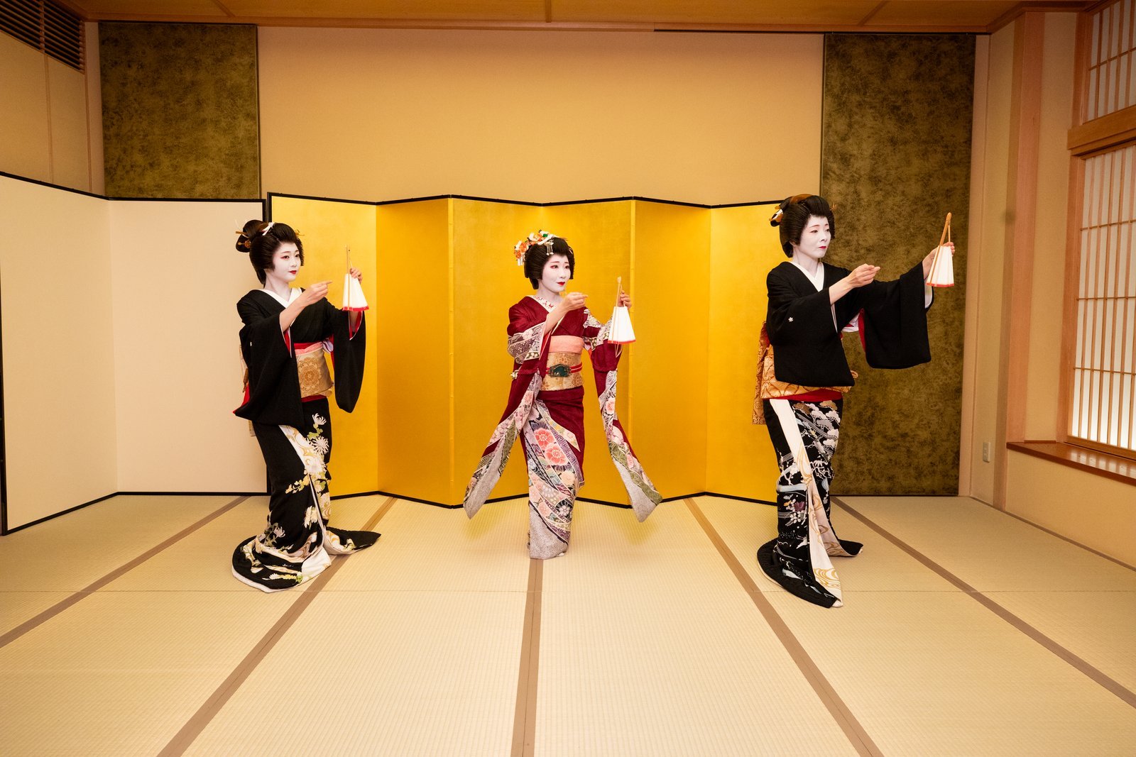 Asakusa geisha performing a traditional fan dance at a private banquet room