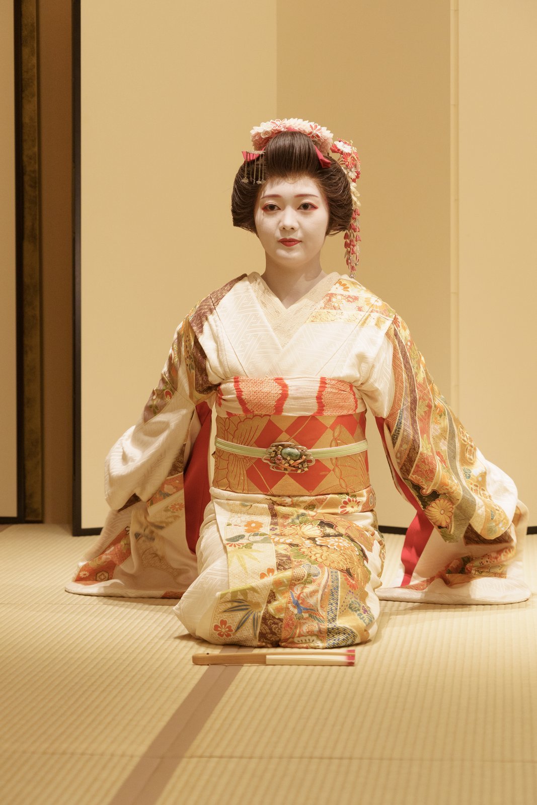 A seated Asakusa hangyoku whose nihongami shows the full outline of the katsura, the wig worn for work