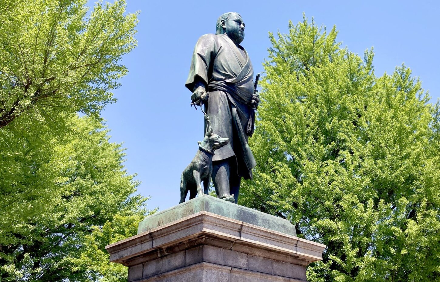 The statue of Saigo Takamori in Ueno Park among fresh green trees