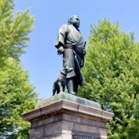 The statue of Saigo Takamori in Ueno Park among fresh green trees