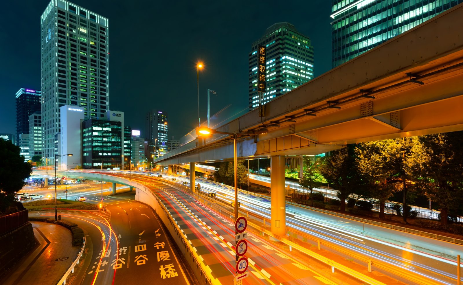 The Akasaka-mitsuke intersection at night, with office towers and car light trails