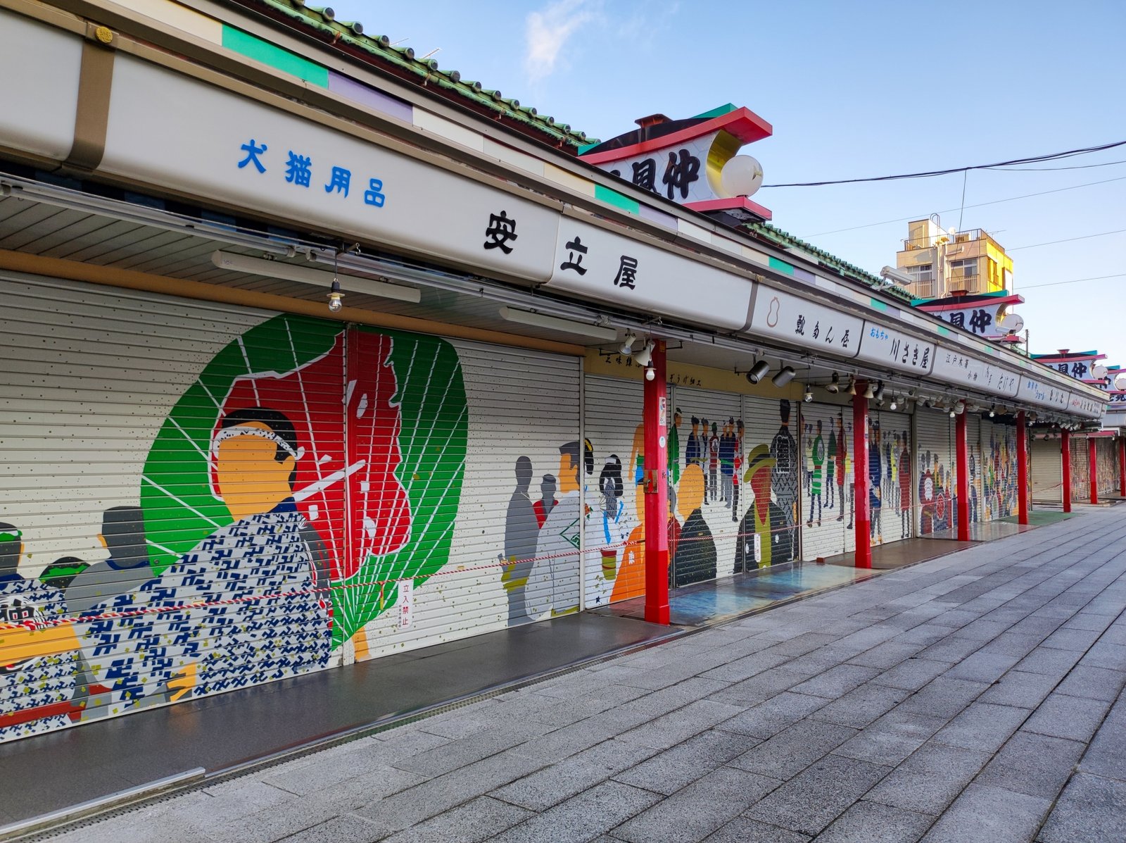 Painted shop shutters along Nakamise Street early in the morning before the shops open