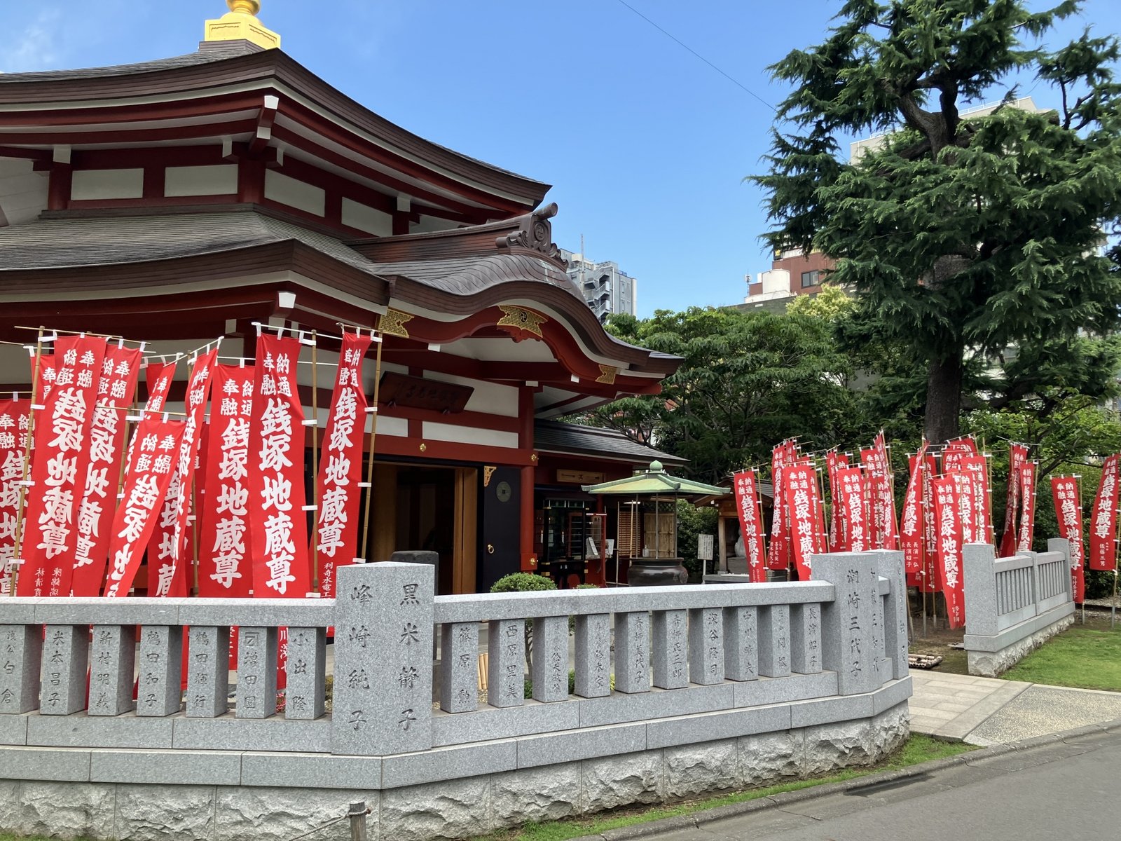 Zenizuka Jizo-do at Senso-ji, lined with red banners