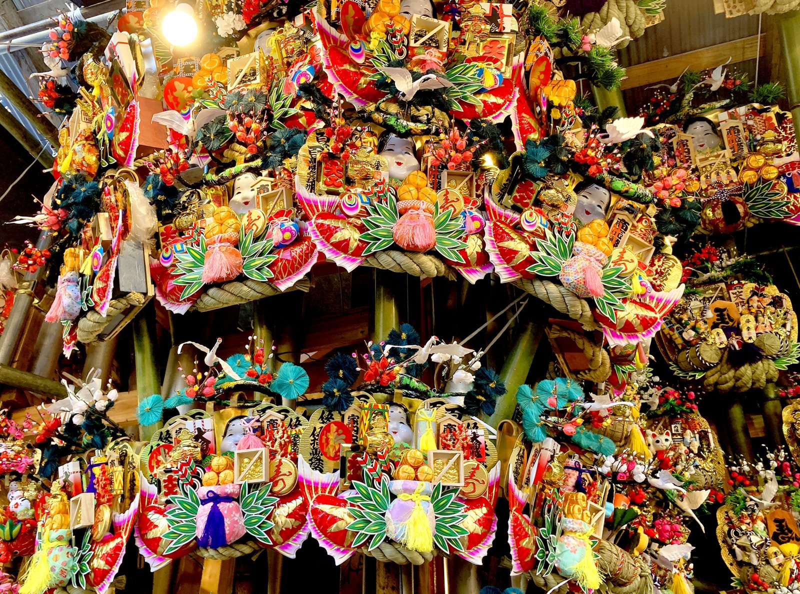 Kumade of every size hung floor to ceiling at a stall at Tori no Ichi